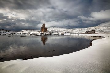 A snow covered landscape by the shore of Loch Assynt with the ruin of Ardvreck Caslte reflecting on the water.<br /><a href="https://fineartamerica.com/featured/ardvreck-castle-in-winter-grant-glendinning.html"><font>Buy Print or Canvas</font></a><a></a> <a href="https://fineartamerica.com/featured/ardvreck-castle-in-winter-grant-glendinning.html"></a><a></a>