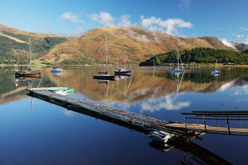 Reflections of sailing boats and mountain scenery from the shore of Loch Leven, Ballachulish. Scotland.<br /><a href="https://shop.photo4me.com/picture.aspx?id=615563&f=canvas"><font>Buy Print or Canvas</font></a><a></a> <a href="https://shop.photo4me.com/picture.aspx?id=615563&f=canvas"><img src="https://www.photoscotland.net/captionpic/p4me.jpg" alt="p4me.jpg" /></a><a></a>