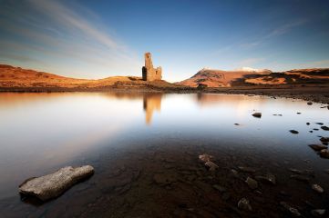 Sunrise at Loch Assynt with the ruin of Ardvreck Castle and the Quinag mountain range reflecting on the water.<br /><a href="https://shop.photo4me.com/278922/canvas"><font color="#f59042">Buy Print or Canvas</font></a><a></a> <a href="https://shop.photo4me.com/278922/canvas"><img src="https://www.photoscotland.net/captionpic/p4me.jpg" alt="p4me.jpg" /></a><a></a>