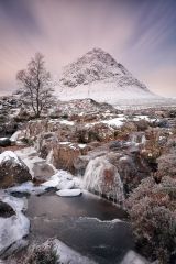 A two minute long exposure of a Scottish highland winter landscape with the snow covered Buachaille Etive Mor (the great herdsman of Etive) and a partially frozen waterfall.<br /><a href="https://shop.photo4me.com/picture.aspx?id=539439&f=canvas"><font>Buy Print or Canvas</font></a><a></a> <a href="https://shop.photo4me.com/picture.aspx?id=539439&f=canvas"></a><a></a>