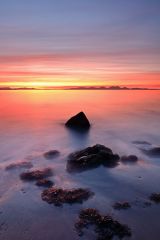 A beautiful and mesmerising Sunset from the rocky west coast of Kintyre with the island of Jura in the distance.<br /><a href="https://shop.photo4me.com/picture.aspx?id=661101&f=canvas"><font>Buy Print or Canvas</font></a><a></a> <a href="https://shop.photo4me.com/picture.aspx?id=661101&f=canvas"><img src="https://www.photoscotland.net/captionpic/p4me.jpg" alt="p4me.jpg" /></a><a></a>