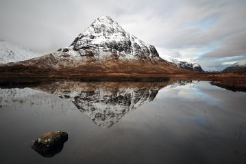 Stob Coire Raineach reflecting on a calm Lochan na Fola near Glencoe in the Scottish highlands.<br /><a href="https://shop.photo4me.com/picture.aspx?id=560557&f=canvas"><font>Buy Print or Canvas </font></a><a href="https://shop.photo4me.com/picture.aspx?id=560557&f=canvas"><img src="https://www.photoscotland.net/captionpic/p4me.jpg" alt="" /></a>